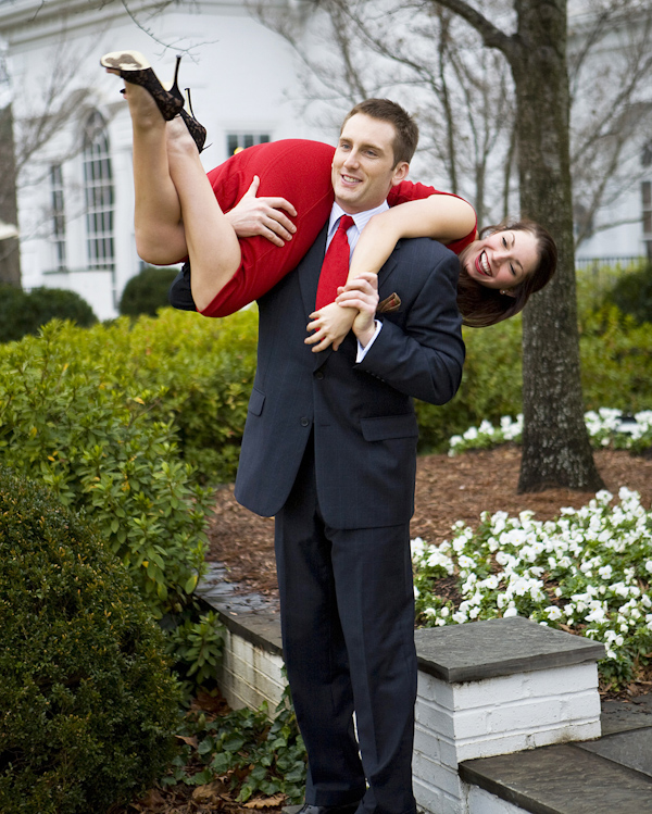engagement photo of the happy couple - the fiance is carrying his fiancee over his shoulder - photo by North Carolina based wedding photographers Cunningham Photo Artists